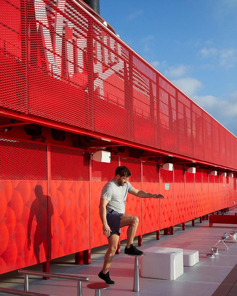 Person working out under the Virgin logo aboard Scarlet Lady