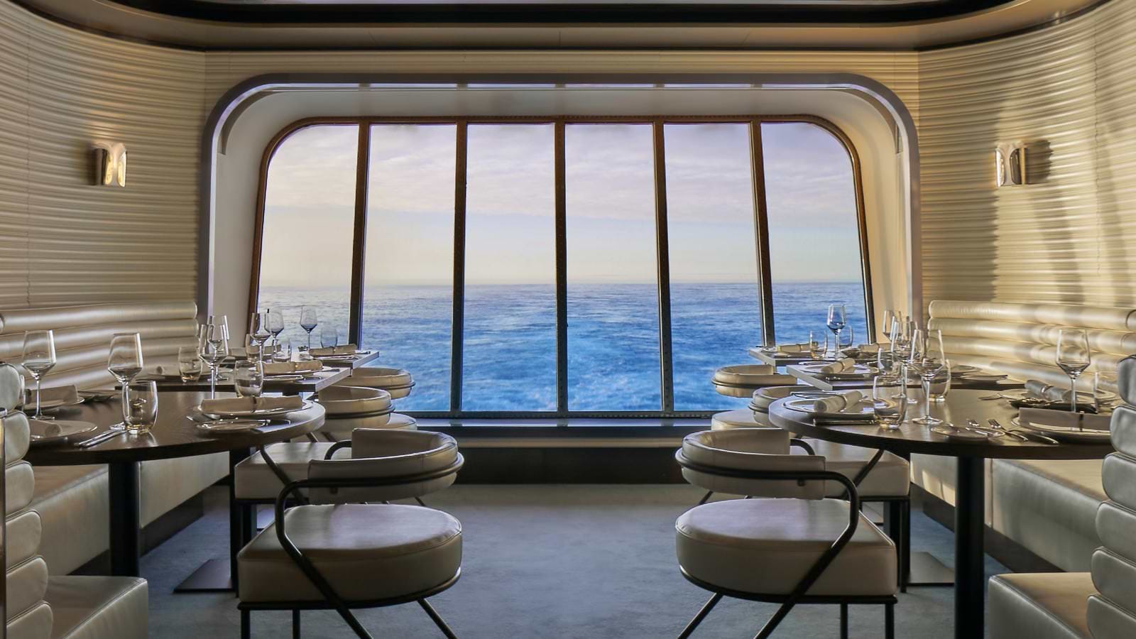 Tables and chairs at The Wake dining room aboard scarlet lady