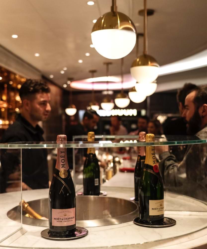 Möet & Chandon champagne bottles displaying at Virgin Voyages' Sip Lounge