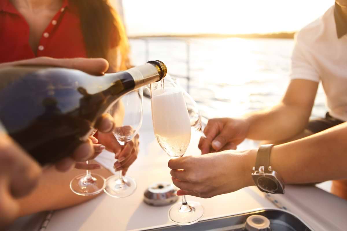 pouring champagne on a boat