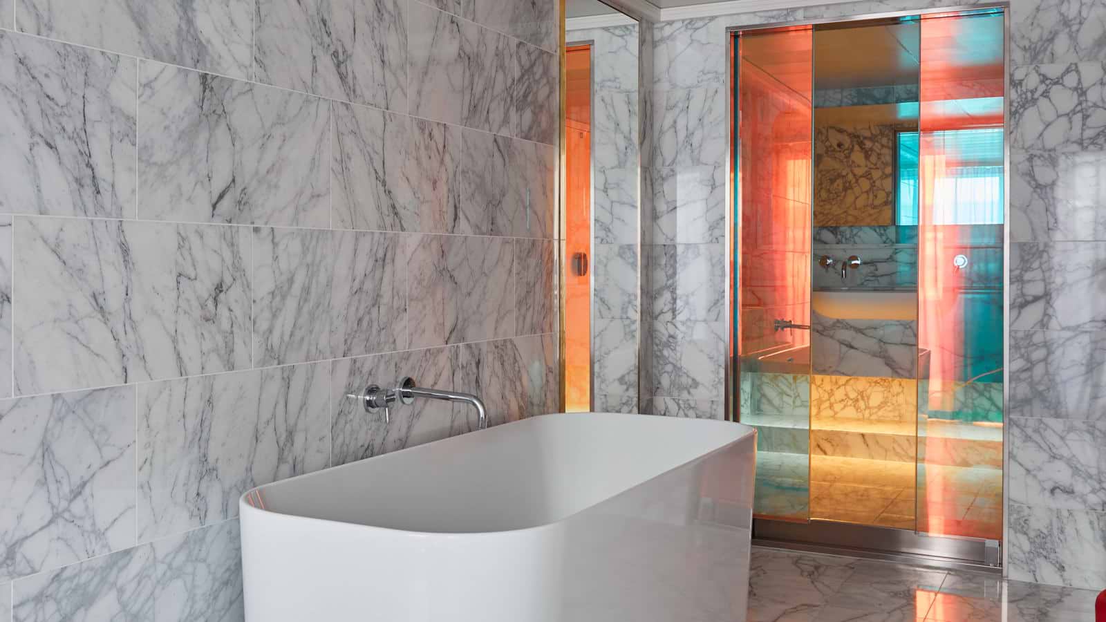 The Massive Suite features 1.5 baths, a standalone tub, floor-to-ceiling marble, and dichroic finishings, plus an (extra) roomy Peek-a-View Shower.