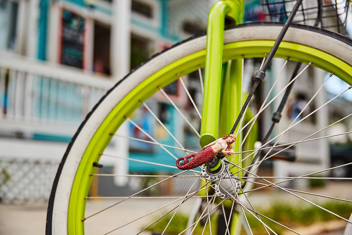 Partial view of lime painted bicycle's wheel 