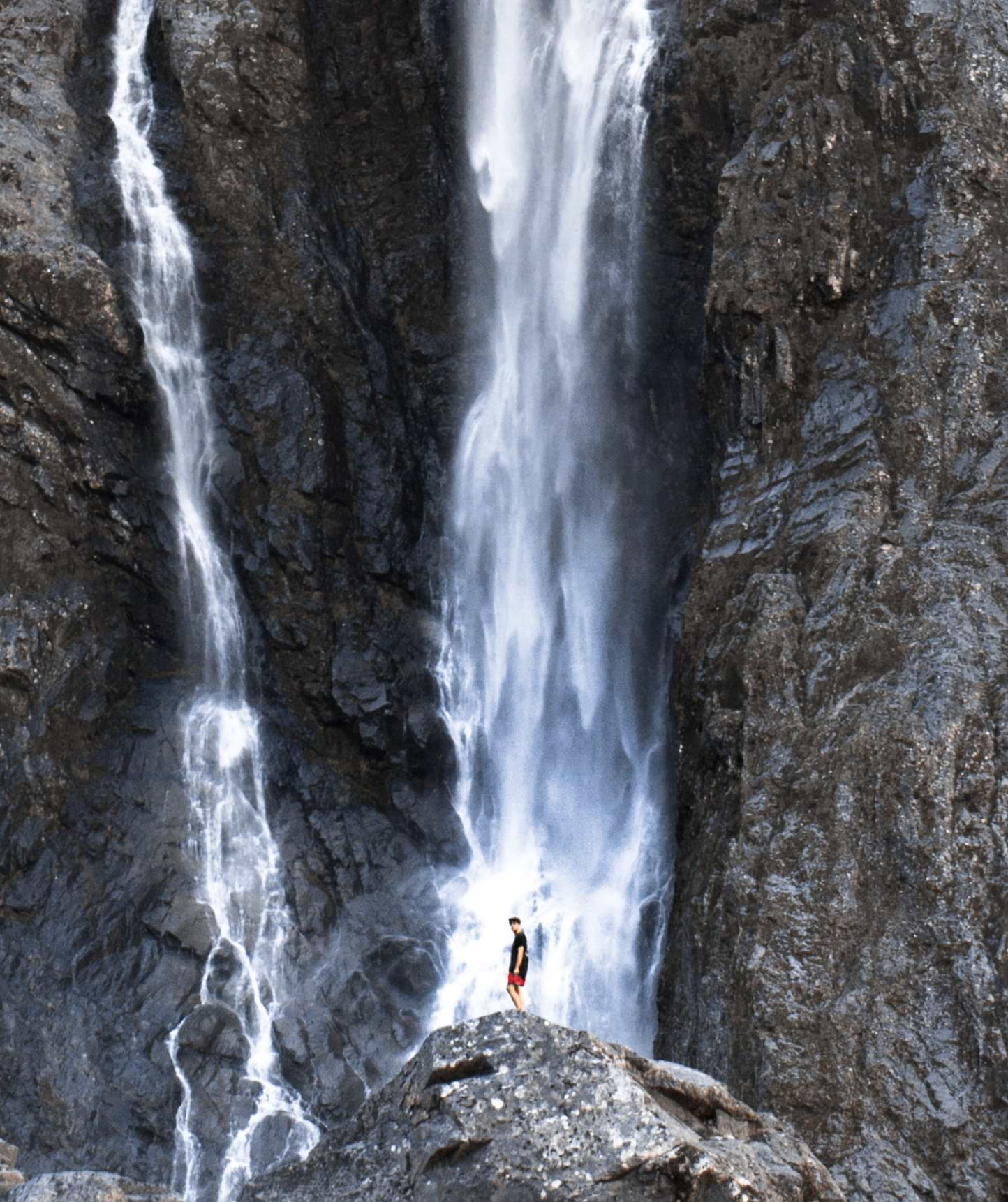 Tasman Sea Fjords and Maori Shores - Man looking at waterfall