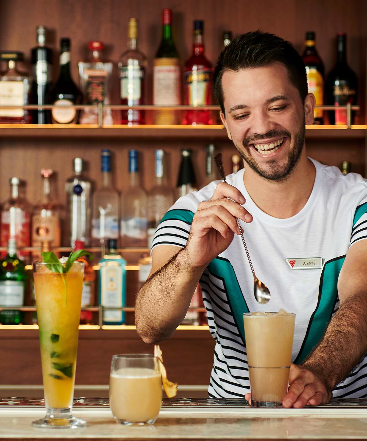 bartender smiling while mixing drink