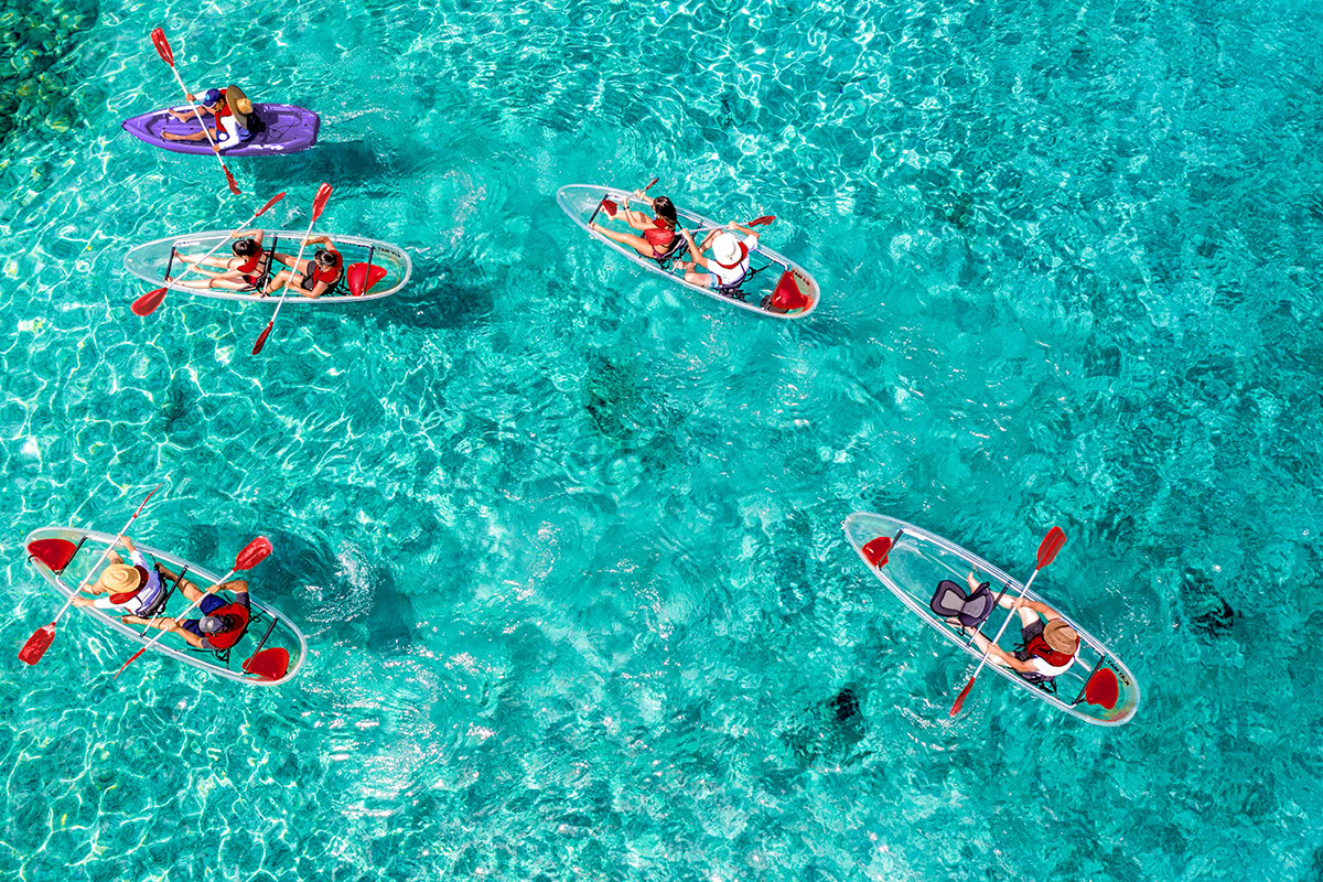 Zenit view of clear bottom kayaks on turquoise waters