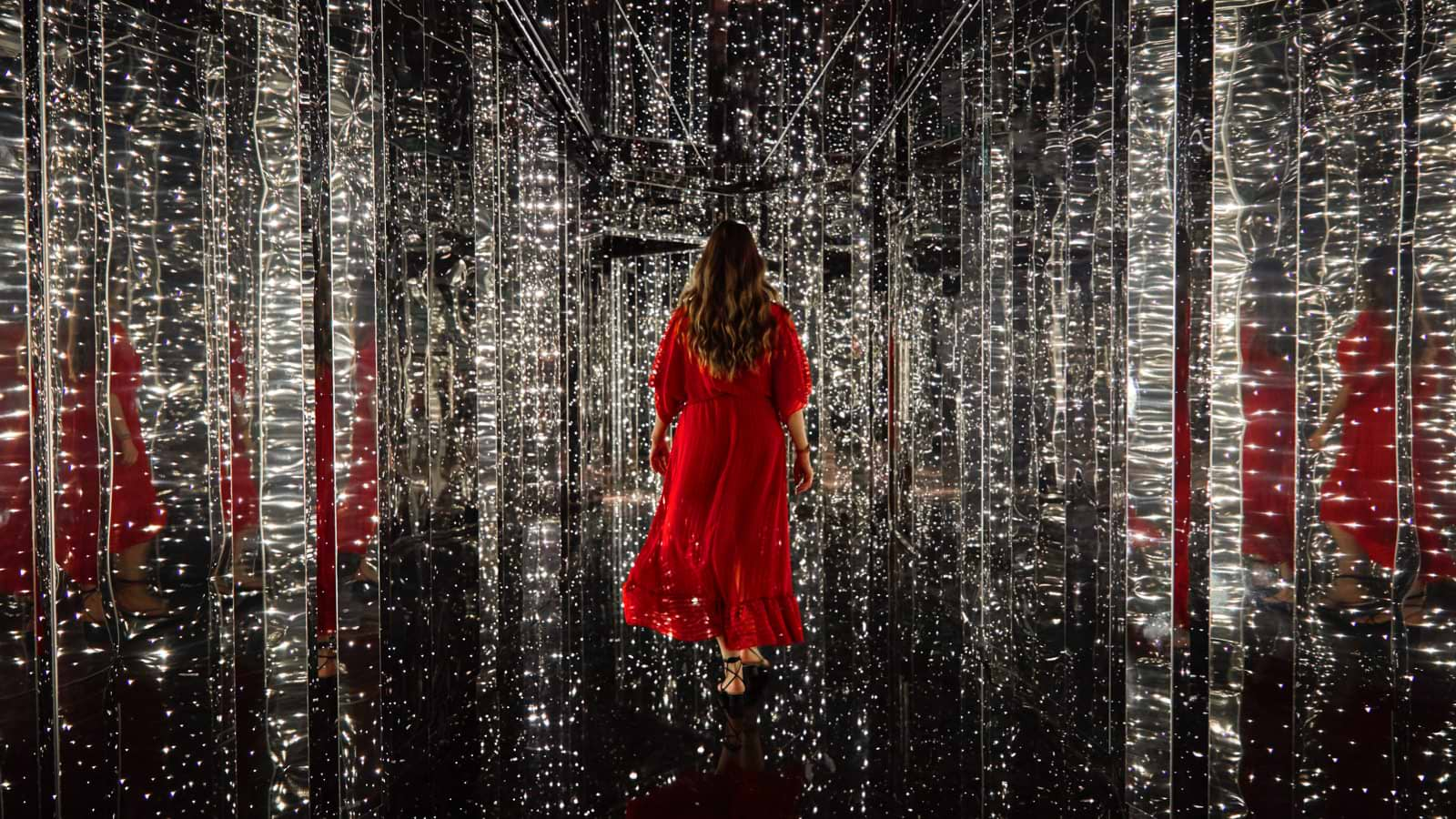 Woman in red dress walking towards The Manor entrance