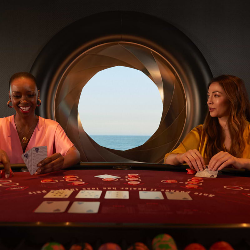 Two girls playing cards at casino