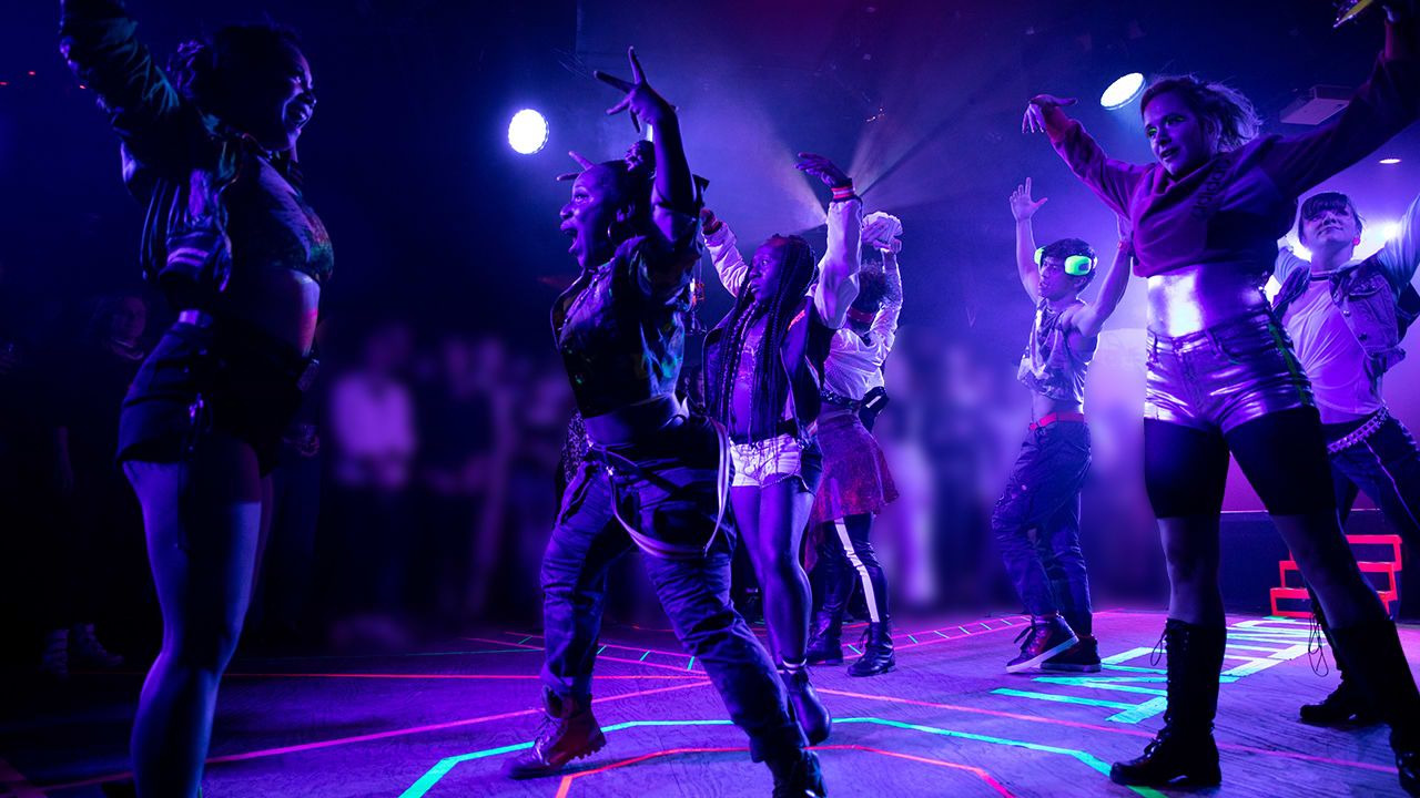 Urban dancer at stage with purple illumination 
