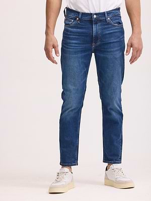 TOMMY HILFIGER jeans גינס בצבע כחול עם שפשופים SLIM FIT